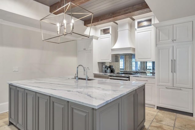 4317 Oglethorpe Loop NW, Acworth, GA 30101 - kitchen featuring custom range hood, gray cabinetry, decorative backsplash, white cabinets, and a kitchen island with sink