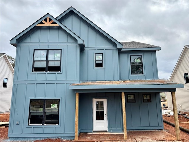 view of front of house featuring roof with shingles and board and batten siding