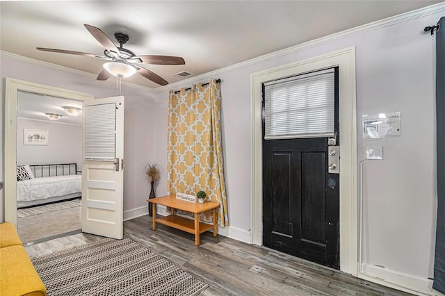 entrance foyer with crown molding, ceiling fan, and hardwood / wood-style floors