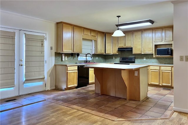 kitchen with light brown cabinets, decorative light fixtures, french doors, black appliances, and a center island