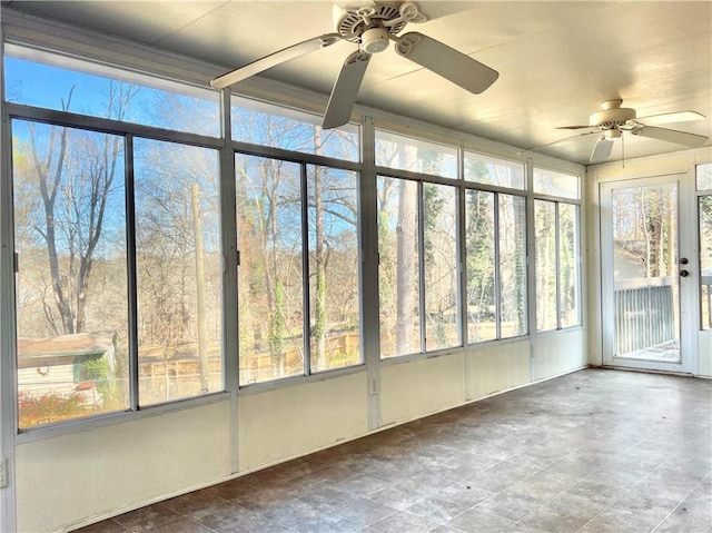 unfurnished sunroom with ceiling fan