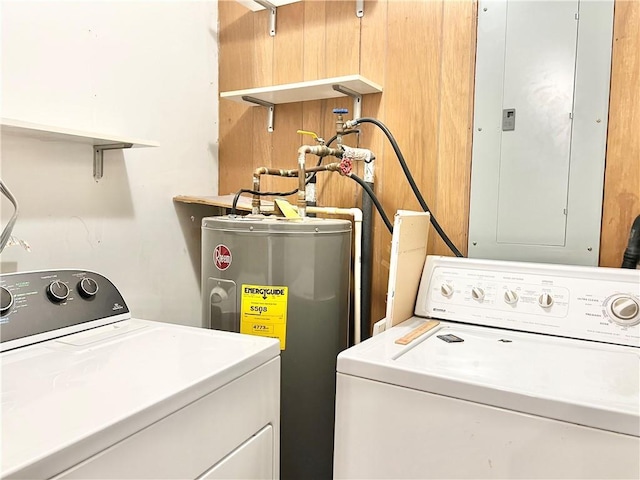 clothes washing area with electric water heater, independent washer and dryer, and electric panel