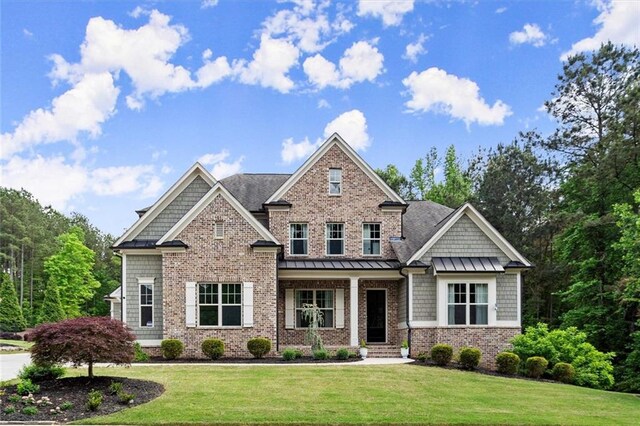 craftsman-style home with a front lawn and a standing seam roof