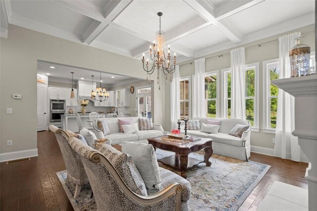 living area featuring baseboards, beam ceiling, a notable chandelier, and dark wood-style floors