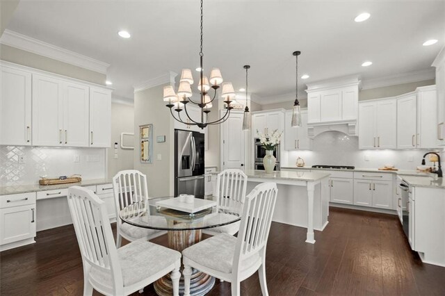 dining space featuring an inviting chandelier, ornamental molding, recessed lighting, and dark wood finished floors