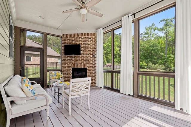 sunroom with plenty of natural light and a ceiling fan