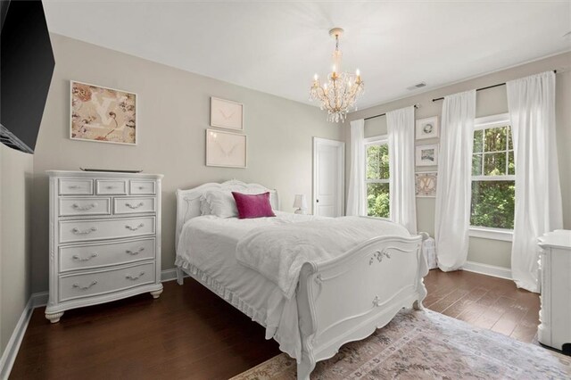 bedroom featuring baseboards, visible vents, a chandelier, and dark wood-style floors