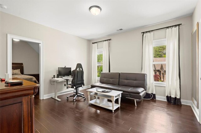 office featuring visible vents, dark wood finished floors, and plenty of natural light
