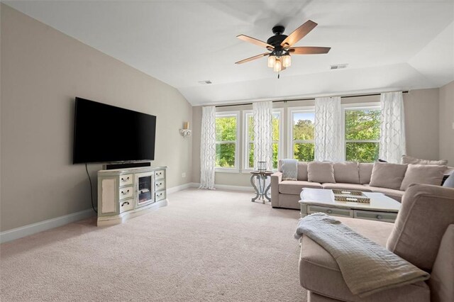 living room featuring baseboards, visible vents, plenty of natural light, and lofted ceiling
