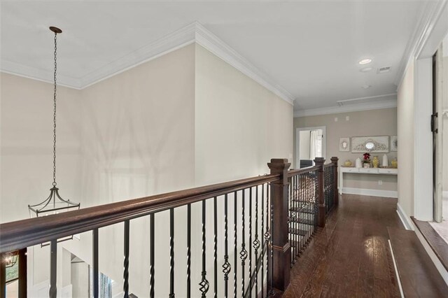 hallway featuring wood-type flooring, crown molding, visible vents, recessed lighting, and an upstairs landing