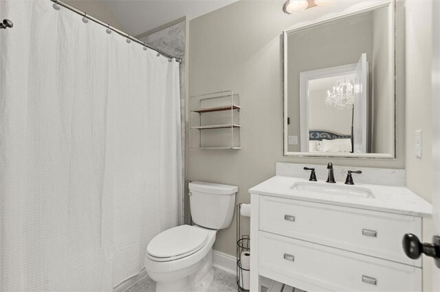 bathroom with toilet, baseboards, tile patterned floors, and vanity