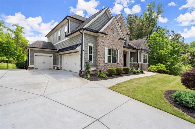 view of front of house featuring roof with shingles, fence, a front yard, and concrete driveway