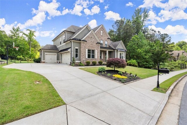 craftsman house featuring an attached garage, a front yard, and concrete driveway