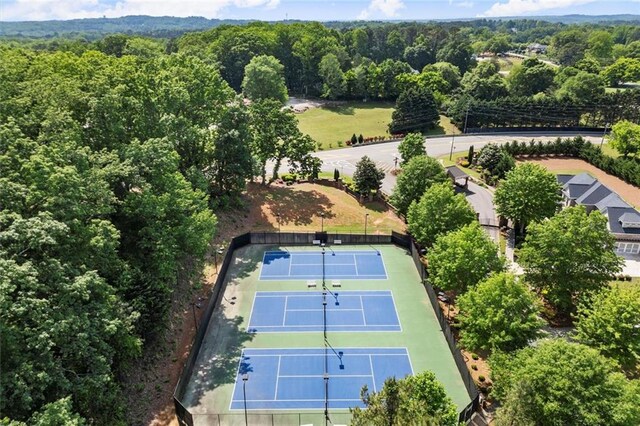 birds eye view of property featuring a wooded view