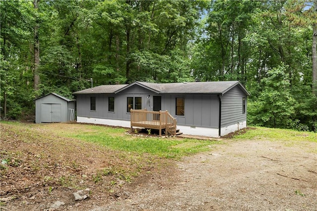 1010 Martin Ln, Canton, GA 30114 - view of front of house with a storage unit, crawl space, a wooden deck, and a shingled roof