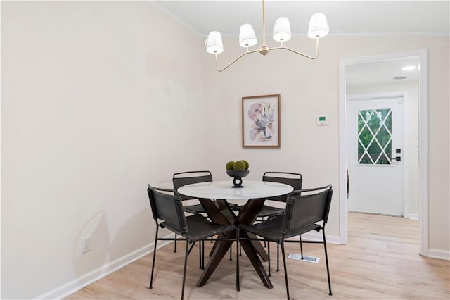 1010 Martin Ln, Canton, GA 30114 - dining room featuring a chandelier, ornamental molding, and light wood-style flooring