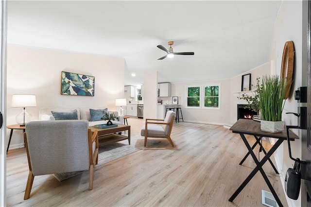 1010 Martin Ln, Canton, GA 30114 - living area featuring a ceiling fan, light wood-type flooring, a lit fireplace, and lofted ceiling