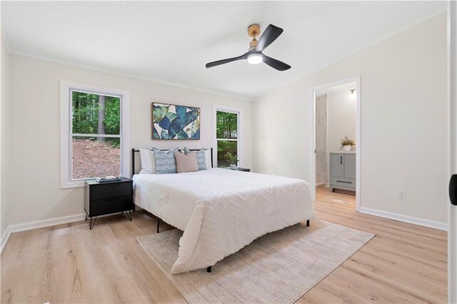 1010 Martin Ln, Canton, GA 30114 - bedroom with multiple windows, light wood-style flooring, a ceiling fan, and connected bathroom