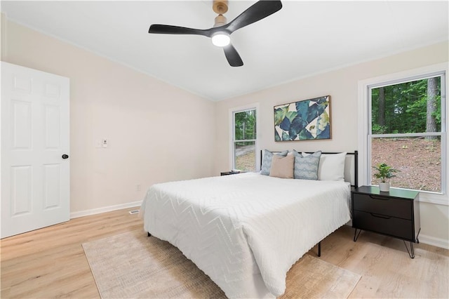1010 Martin Ln, Canton, GA 30114 - bedroom with light wood-style flooring, multiple windows, and ceiling fan