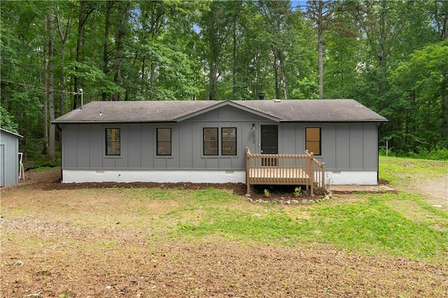 1010 Martin Ln, Canton, GA 30114 - ranch-style house with board and batten siding, a front yard, roof with shingles, and a deck