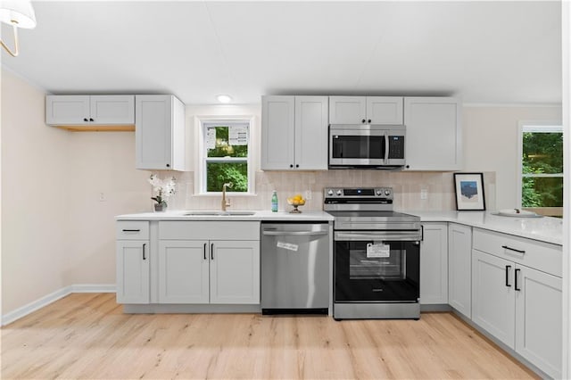 1010 Martin Ln, Canton, GA 30114 - kitchen with stainless steel appliances, decorative backsplash, light wood-style floors, recessed lighting, and crown molding