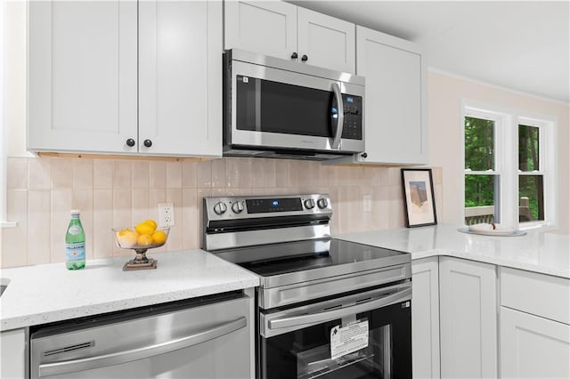 1010 Martin Ln, Canton, GA 30114 - kitchen with stainless steel appliances, decorative backsplash, light stone counters, and white cabinets