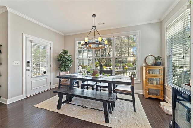 dining space with a chandelier, dark wood-type flooring, baseboards, and ornamental molding