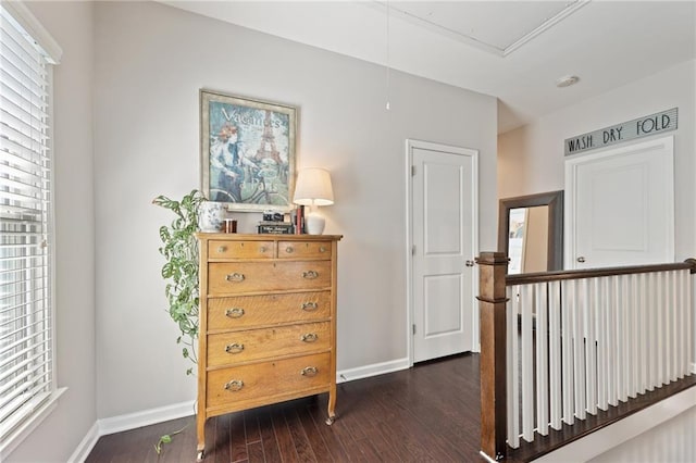 living area with baseboards and dark wood finished floors