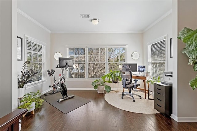 exercise area with ornamental molding, dark wood-type flooring, and baseboards