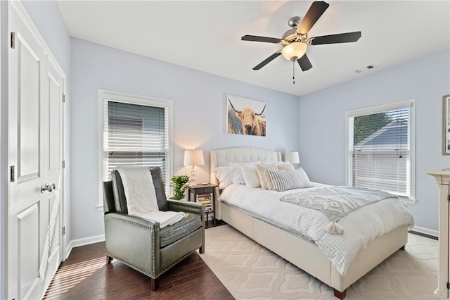 bedroom with light wood-style floors, baseboards, and ceiling fan