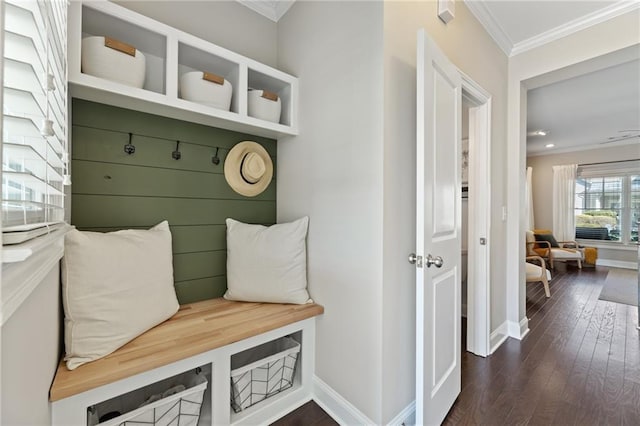mudroom with ornamental molding, dark wood-type flooring, and baseboards