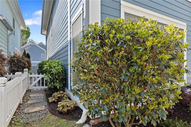view of side of home featuring fence