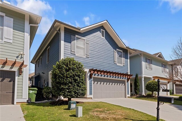 view of front facade featuring driveway, a garage, and a front yard