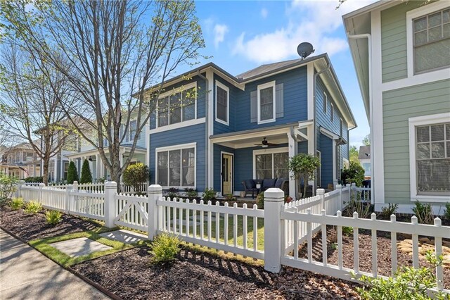 view of front facade featuring ceiling fan, a fenced front yard, and a porch