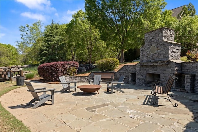 view of patio with an outdoor stone fireplace