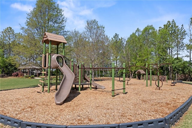 community playground with a yard and view of scattered trees