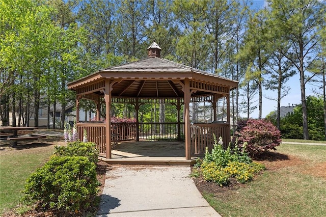 view of community with a gazebo, driveway, and a carport