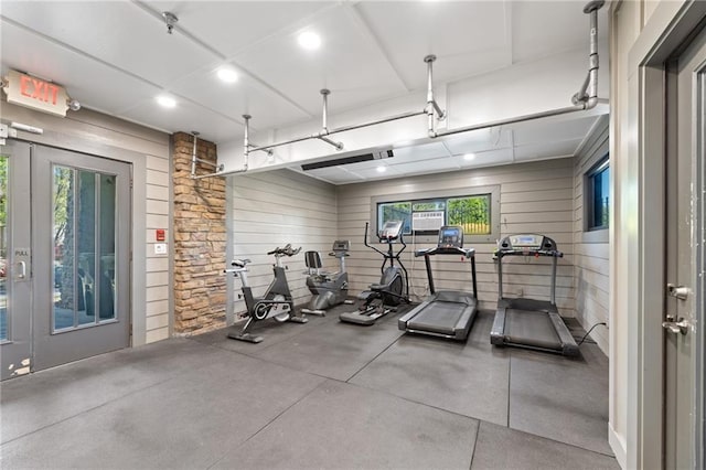 gym with plenty of natural light, wood walls, and recessed lighting