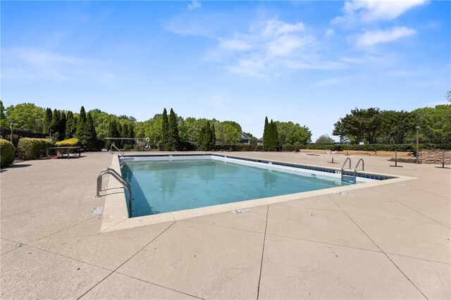 community pool with a patio area