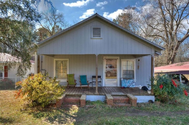 rear view of house with covered porch