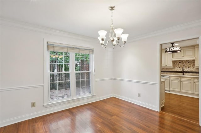 unfurnished dining area featuring ornamental molding, sink, a notable chandelier, and dark hardwood / wood-style flooring