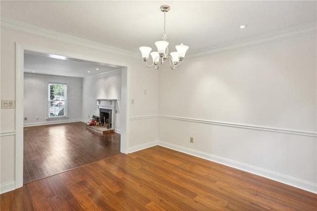 interior space featuring a notable chandelier, wood-type flooring, and ornamental molding