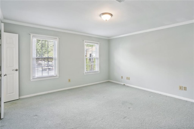 spare room featuring ornamental molding and light colored carpet