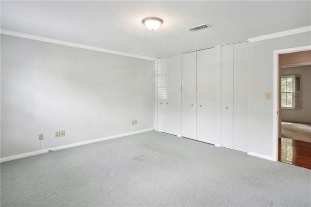 unfurnished bedroom with crown molding and carpet floors