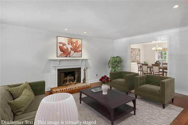 living room featuring ornamental molding, a chandelier, and wood-type flooring