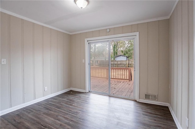 empty room with ornamental molding and dark wood-type flooring