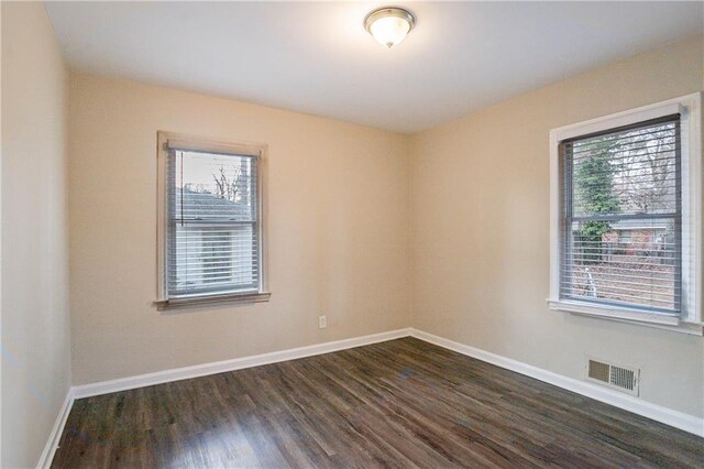 empty room featuring dark hardwood / wood-style flooring