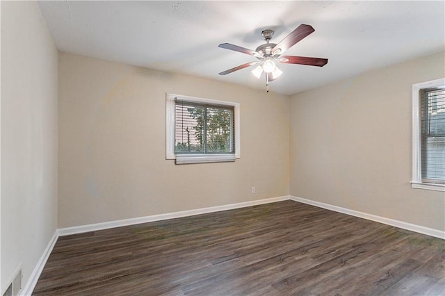 empty room with dark hardwood / wood-style floors and ceiling fan