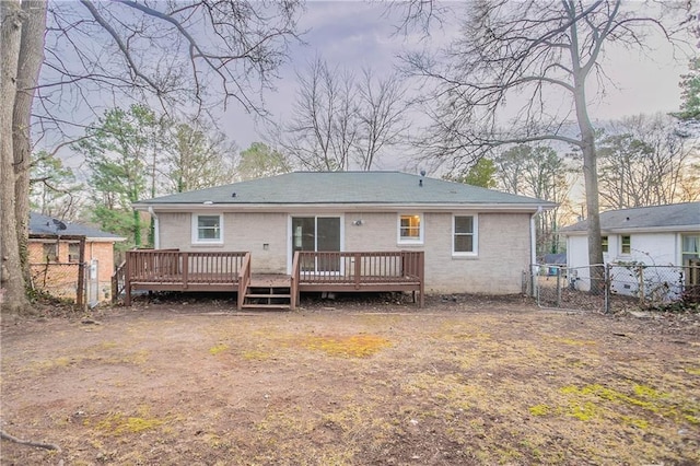 rear view of property featuring a deck