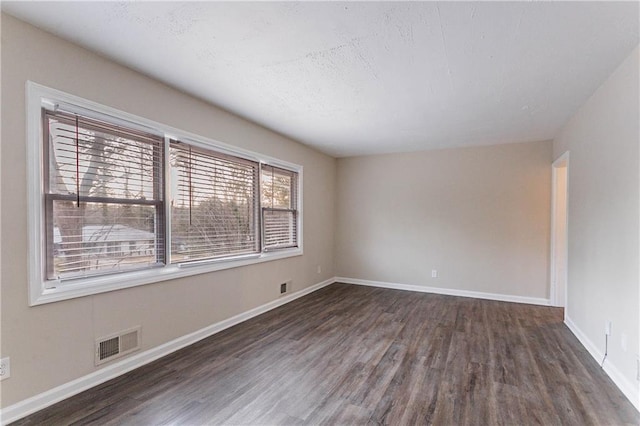 empty room featuring dark wood-type flooring